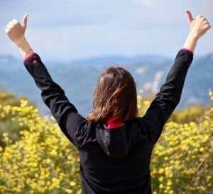 woman with two thumbs up